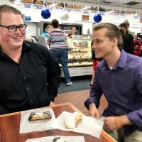JMU undergraduates Charles Boyd and Chase Collins celebrate their first conference presentation with cannolis
