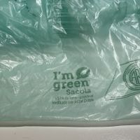 Close-up of a green plastic bag with a icon that says "I'm Green."